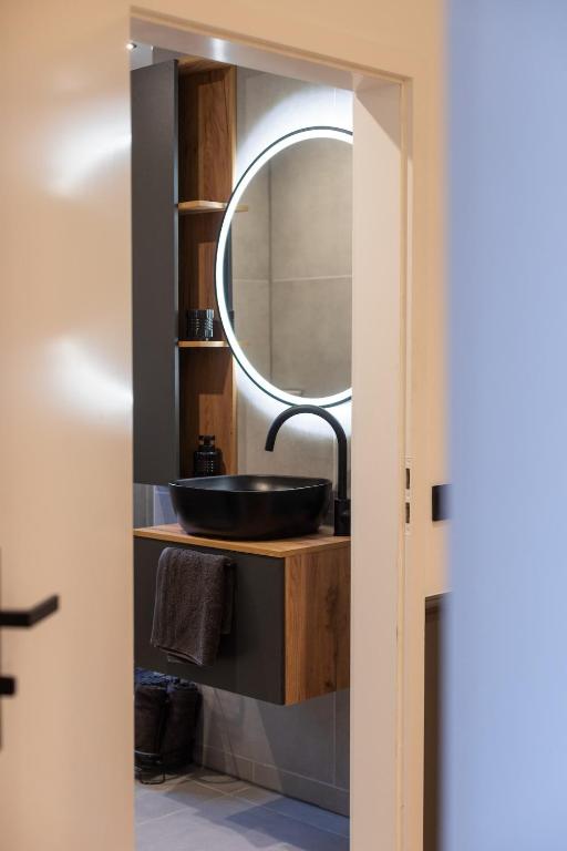 a bathroom with a sink and a mirror at Mokka Suite Design in Neumünster in Neumünster