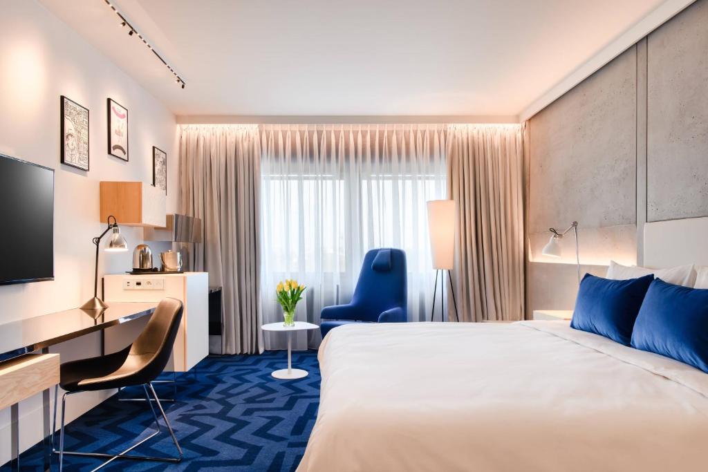 a hotel room with a bed and a desk at Renaissance Warsaw Airport Hotel in Warsaw