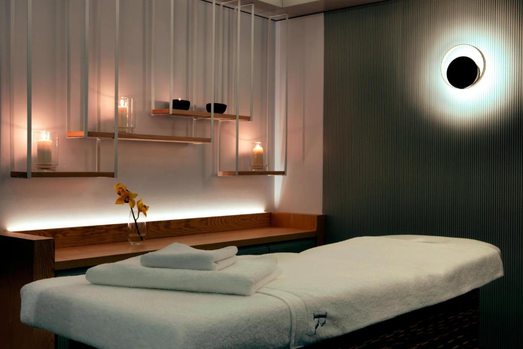 a room with a bed in a room with lights at Renaissance Warsaw Airport Hotel in Warsaw