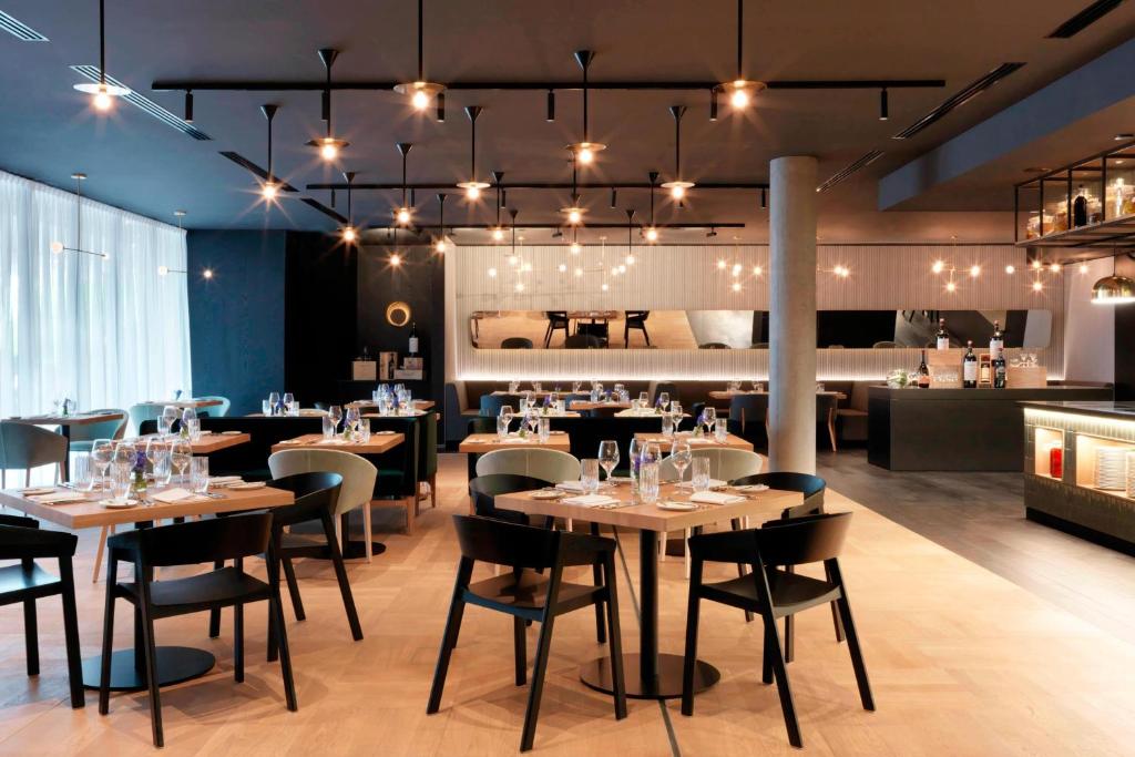 a restaurant with tables and chairs in a room at Renaissance Warsaw Airport Hotel in Warsaw