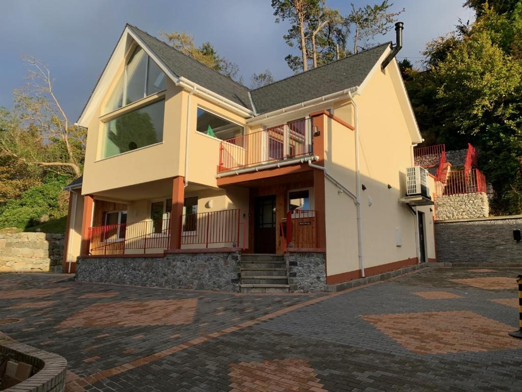 a house with a porch and a balcony at The Owlery in Fort William