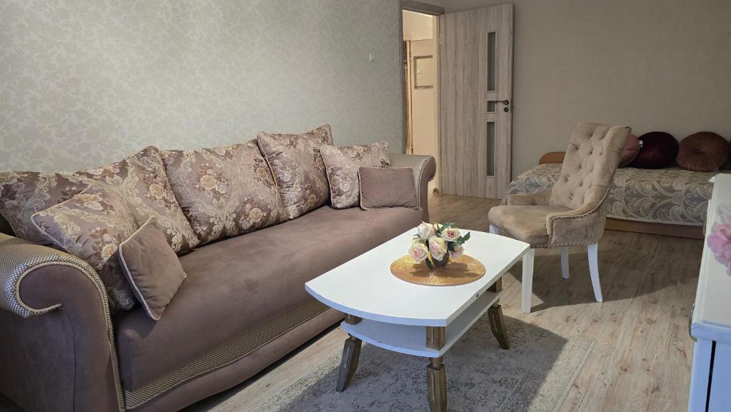 a living room with a couch and a table at Dviejų kambarių butas in Tauragė