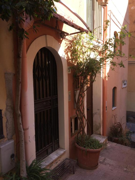 an entrance to a building with a black door at TINY HOUSE in the HEART of TAORMINA in Taormina