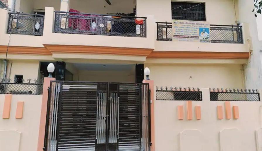 a building with a black gate in front of it at Lokbhgwat house in Jhūsi
