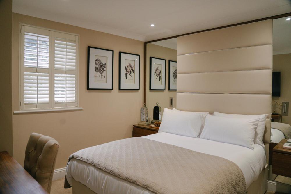 a bedroom with a white bed and a window at 40 Winks Hospitality in Durham