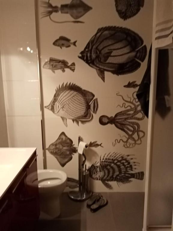 a bathroom with a fish mural on the wall at B&B Il Faraglione Bianco in Vieste