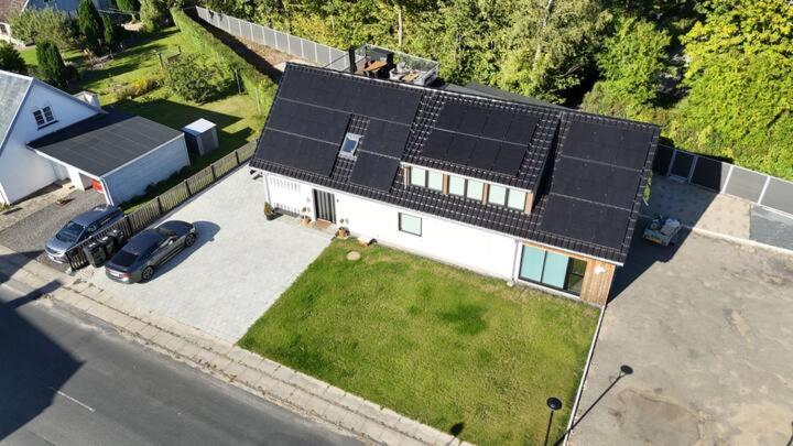 an aerial view of a house with solar panels on it at Charming house for 11 persons in Odense with Luxury Rooftop Deck & Free Parking in Odense