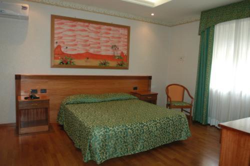 Postel nebo postele na pokoji v ubytování Hotel Verdi