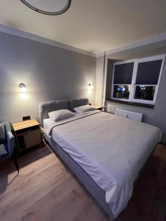 a bedroom with a large bed and a window at Mare et Ventus in Ventspils