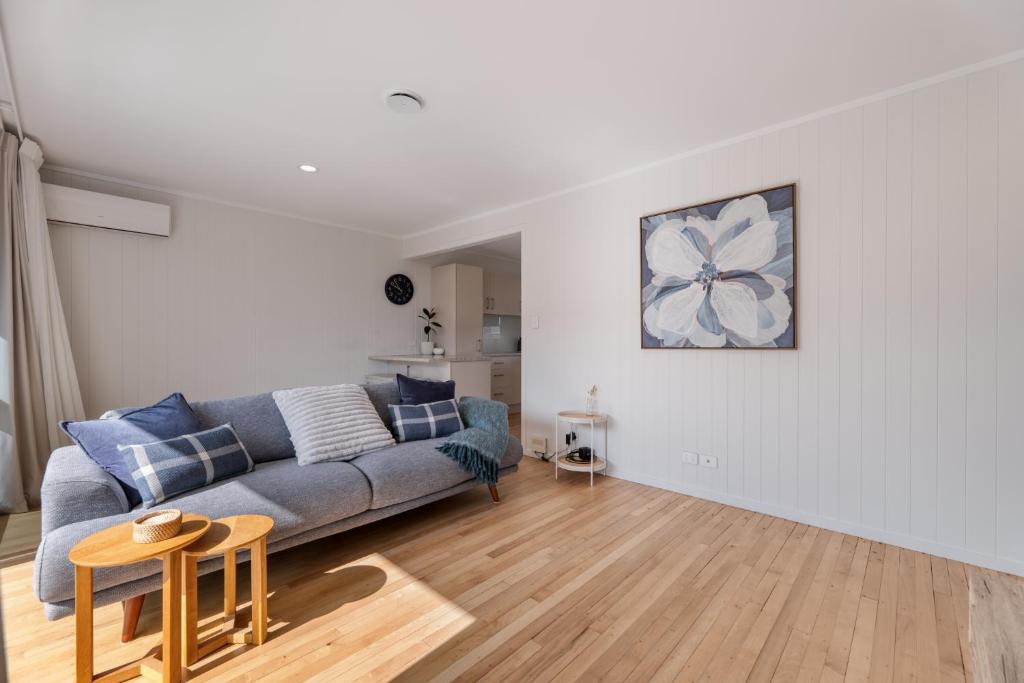 a living room with a couch and a table at Mount Central Hideaway in Mount Maunganui