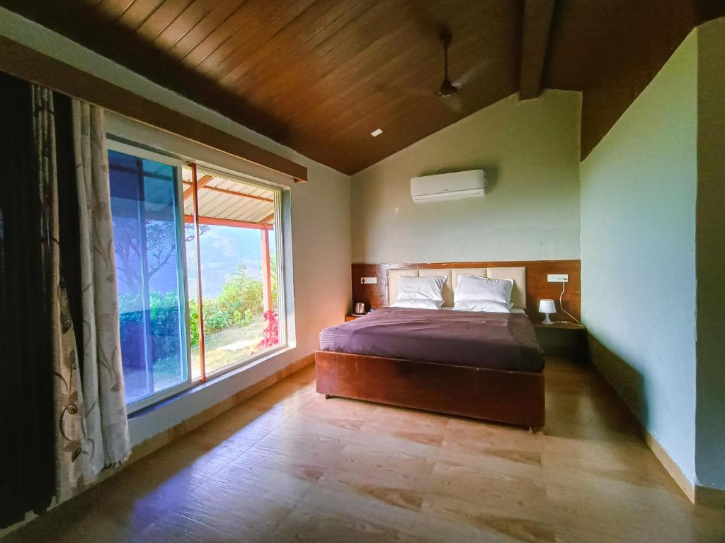 Postel nebo postele na pokoji v ubytování Mysticstays Resort