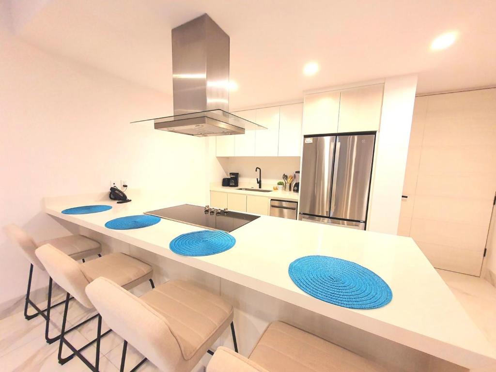 a kitchen with a counter with blue plates on it at Amaterra 304D Seaside Luxe Condo in Cabo San Lucas