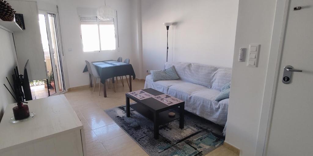 a living room with a couch and a table at Casa Dolores in Puerto de Mazarrón
