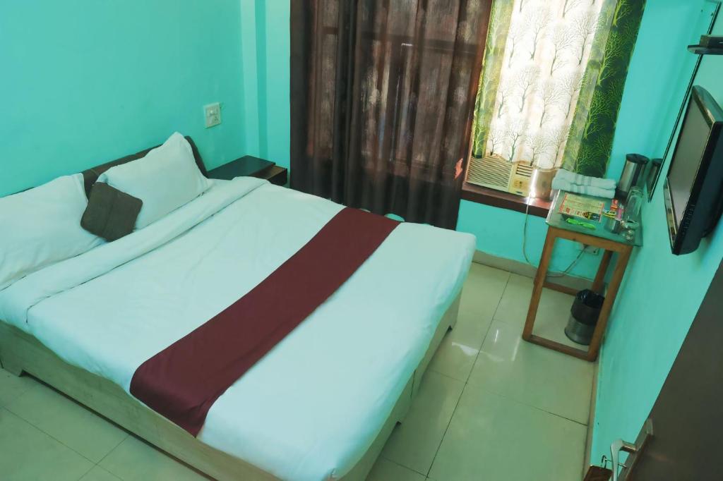 Postel nebo postele na pokoji v ubytování Hotel Shaurya