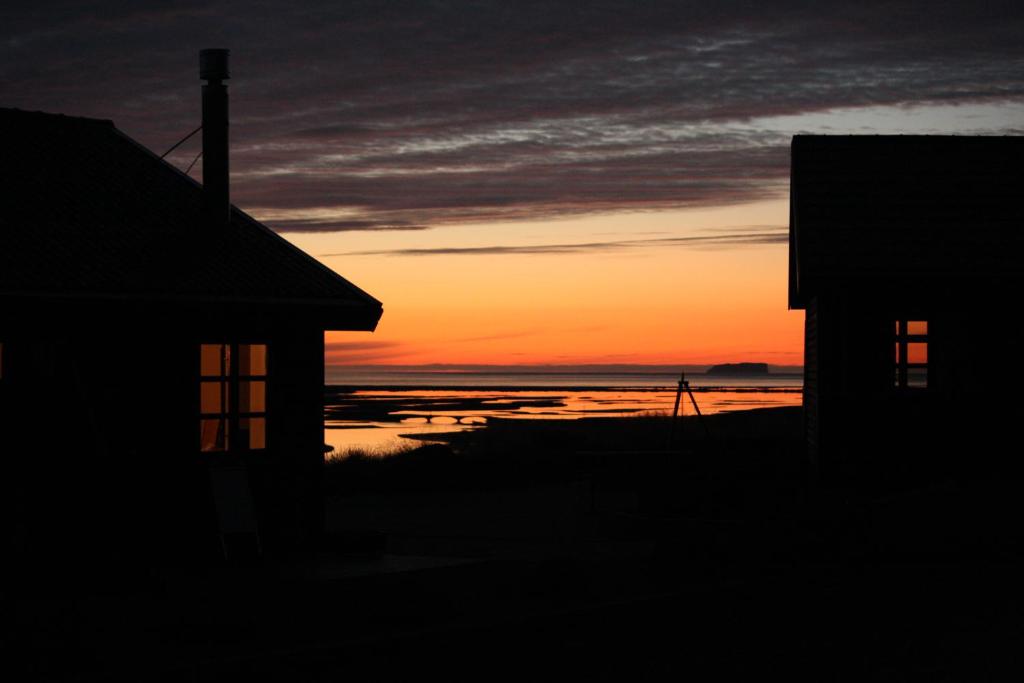 a view of a sunset from a boat on the water at Hofsstadir - Country Hotel in Hofstaðir