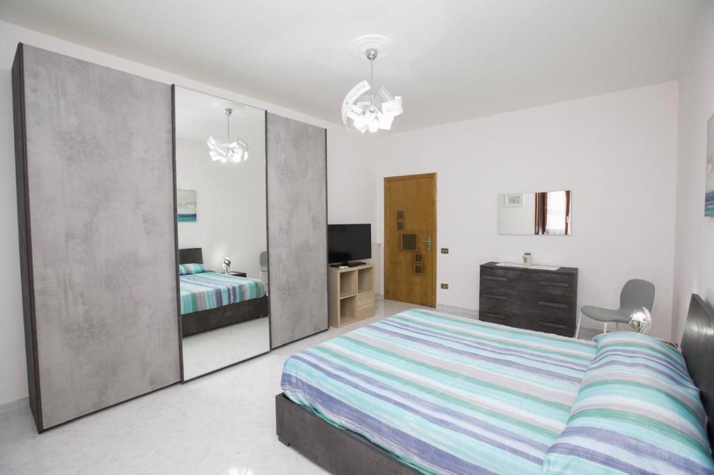 una camera da letto con un letto, una scrivania e uno specchio di La Dea del mare a Maiori