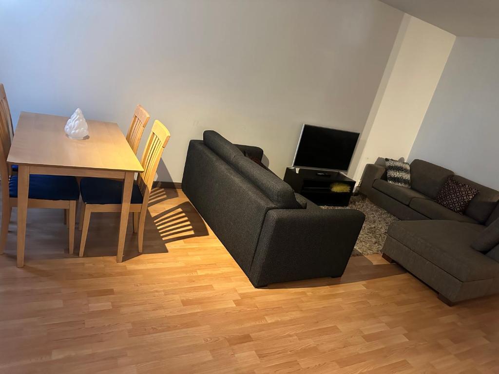 a living room with a couch and a table at Helsinki Sweet Homes in Helsinki