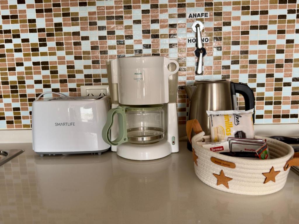 a kitchen counter with a coffee maker and a toaster at BRISApartament a cuadras del mar, moderno y confortable in Puerto Madryn
