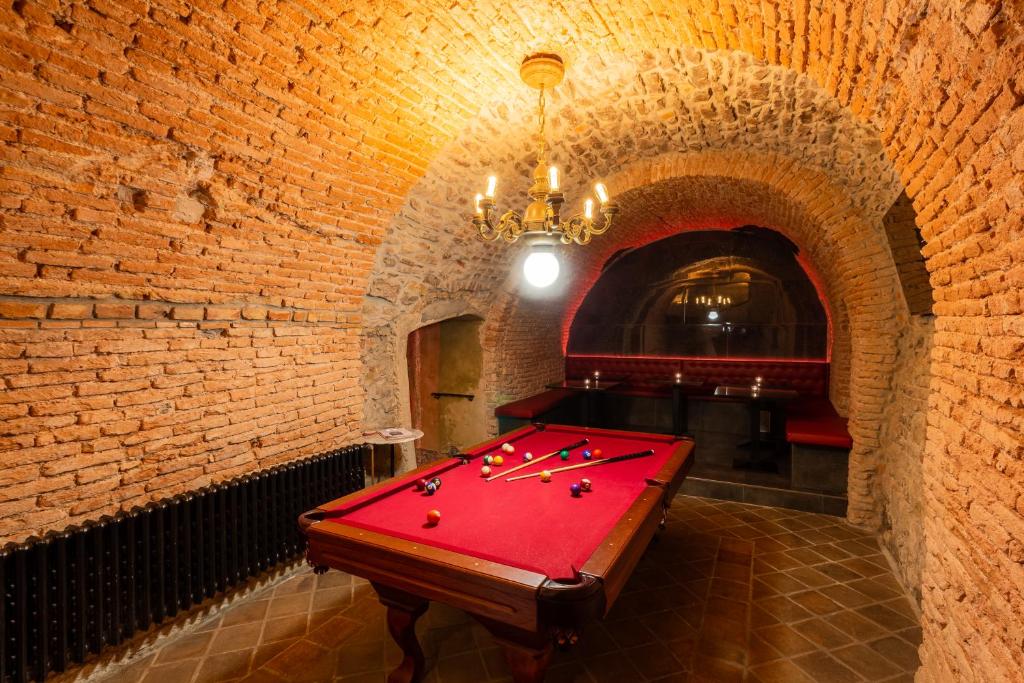 a room with a pool table in a brick wall at Studio Nicolas II Prague in Prague