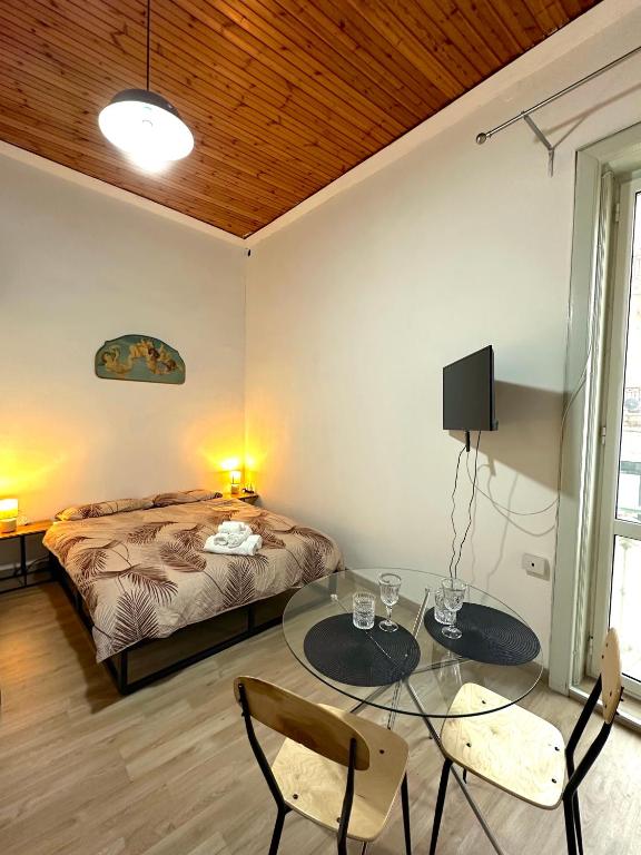 a bedroom with a bed and a glass table at Come a casa in Trani