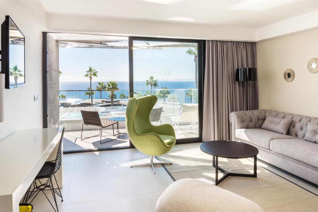 a living room with a view of the ocean at La Isla y el Mar, Hotel Boutique in Puerto del Carmen