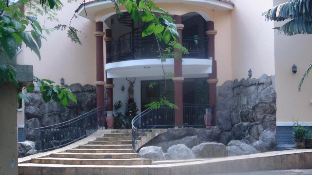 a building with stairs in front of a building at Njiro Ebenezer Retreat Lodge in Arusha