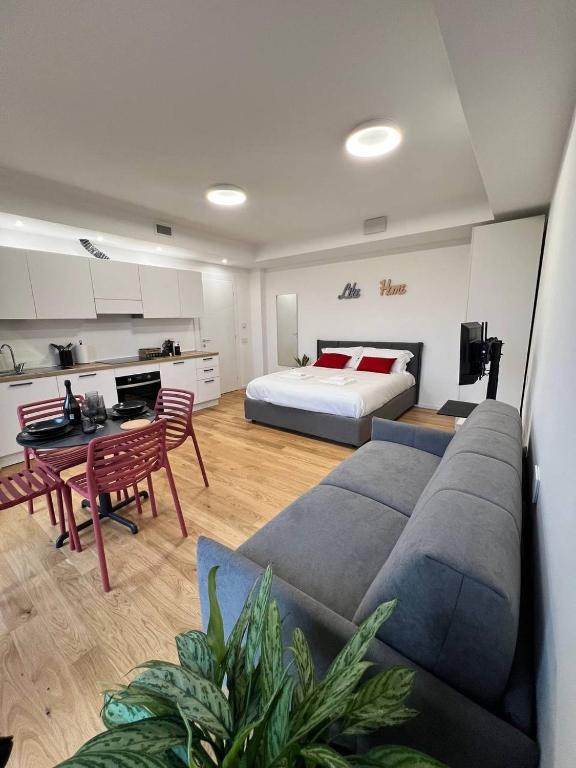 a living room with a couch and a bed at LikeHome PortaReno Monolocale Exclusive - 4 pxs in Ferrara