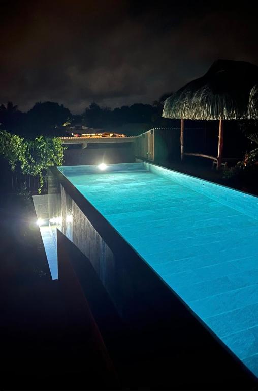 a swimming pool lit up at night at Maharepa Lodges Vue sur les étoiles in Maharepa
