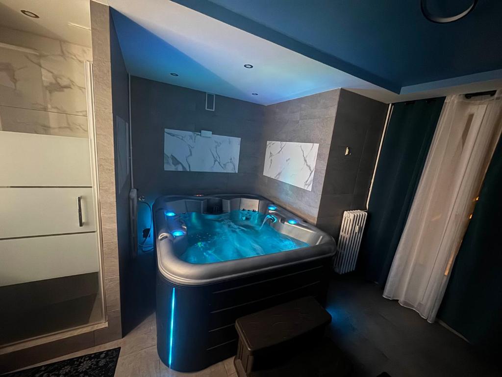 La salle de bains est pourvue d'une baignoire bleue. dans l'établissement Appartement neuve avec jacuzzi, à Orléans