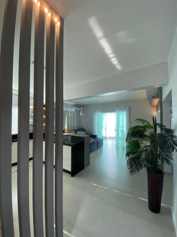 a living room with a potted plant in a building at Apartamento 301 in Piratuba