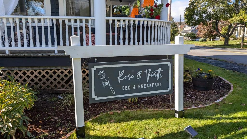 a sign for a home of worship in front of a house at Rose & Thistle B&B Lunenburg in Lunenburg