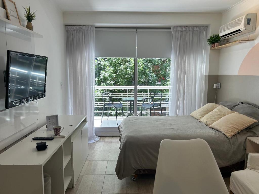 a bedroom with a bed and a desk and a window at Monoambiente lujoso en Cañitas! in Buenos Aires