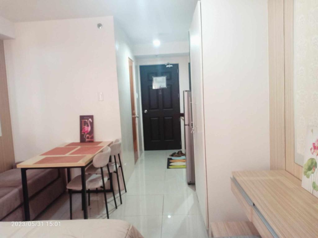 a small room with a table and a dining room at GracieBella 1111 Home in Cebu City