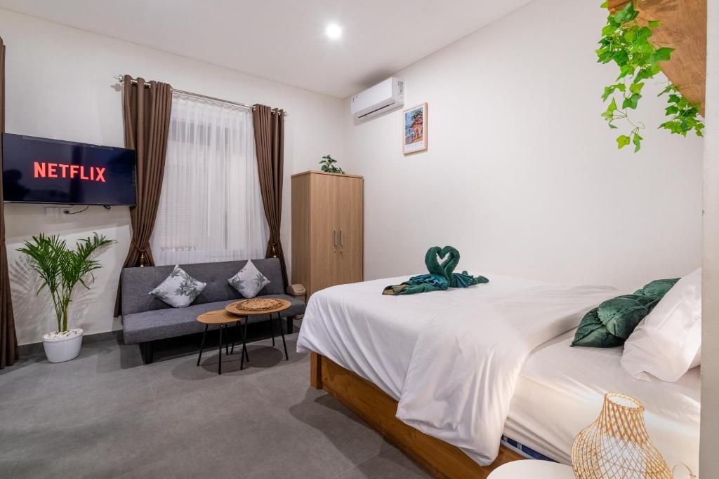 a hotel room with a bed and a couch at Standart Room in Sanur