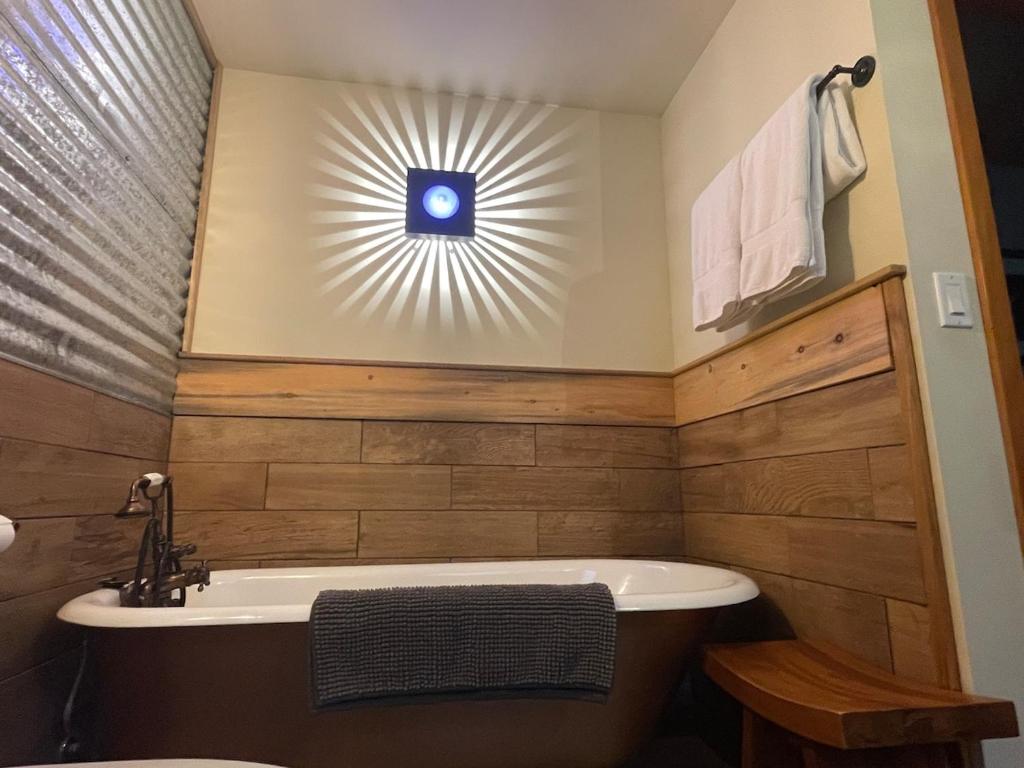 a bathroom with a bath tub and a sun window at Cozy Spa Sanctuary - Steps to Restaurants and Shopping in Portland