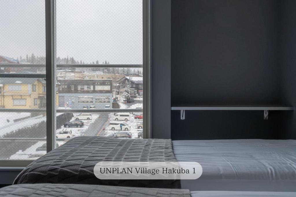 Postel nebo postele na pokoji v ubytování UNPLAN Village Hakuba