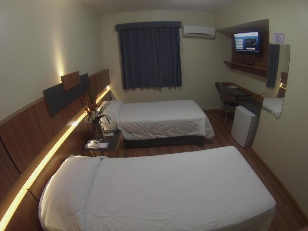 Postel nebo postele na pokoji v ubytování Hotel Aero Park e Estacionamento