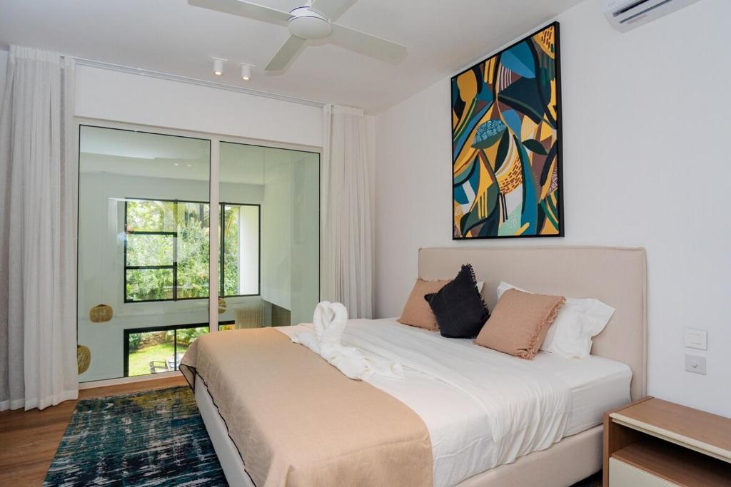 a bedroom with a large bed and a window at The Luxe Retreat - Chic & Comfy in Grand Baie