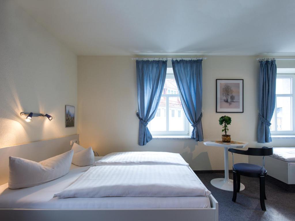 Łóżko lub łóżka w pokoju w obiekcie Pension Lausitz