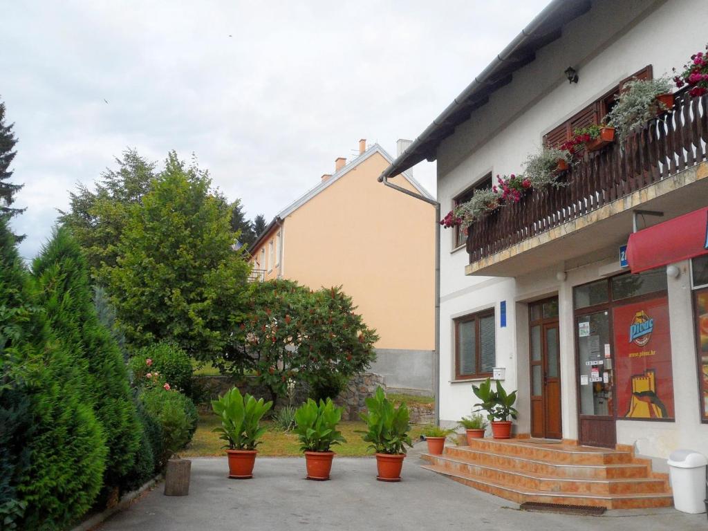 a building with potted plants in front of it at Apartment Rendulic in Rakovica