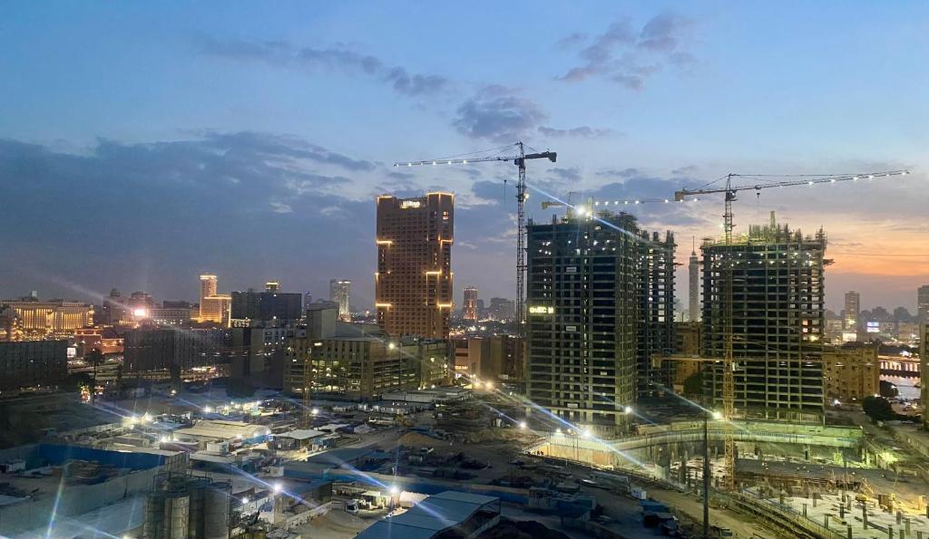 a view of a city at night with buildings at Room for rent - downtown in Cairo