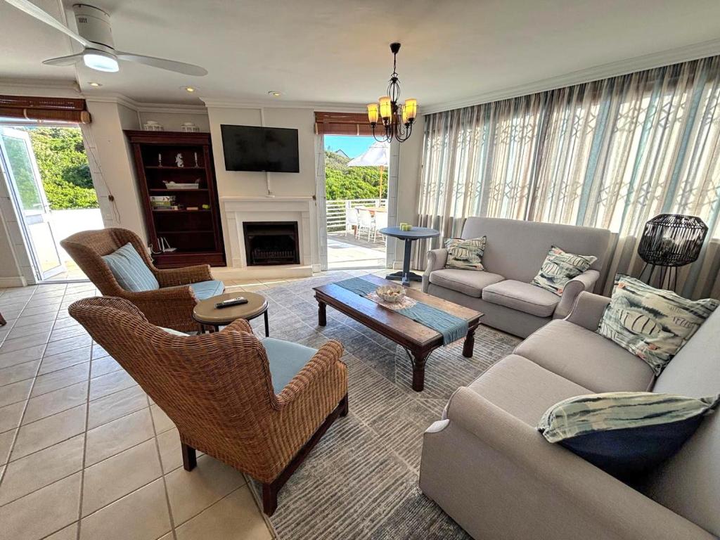 a living room with a couch and a table at Low tide at no 35 in St Francis Bay