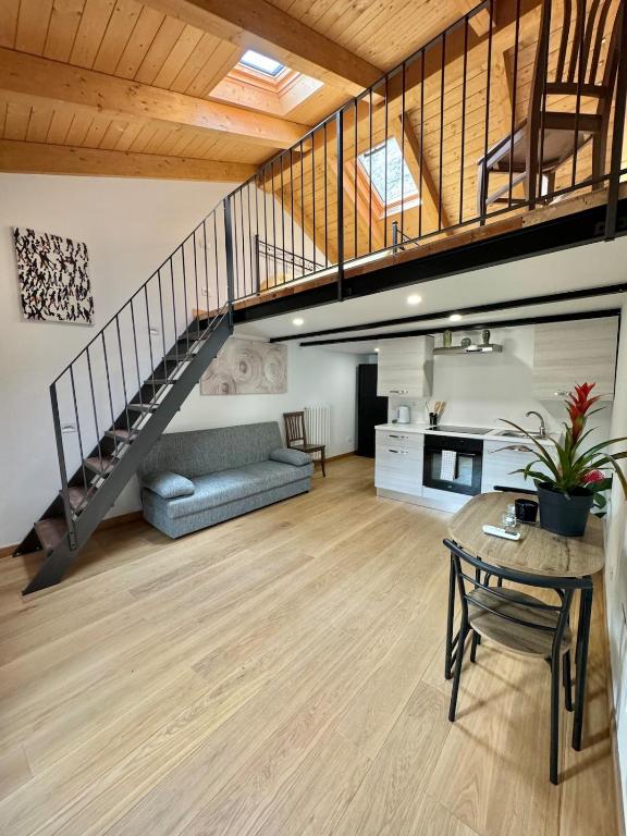 a living room with a staircase and a couch at La piccola Maison in Mondovì
