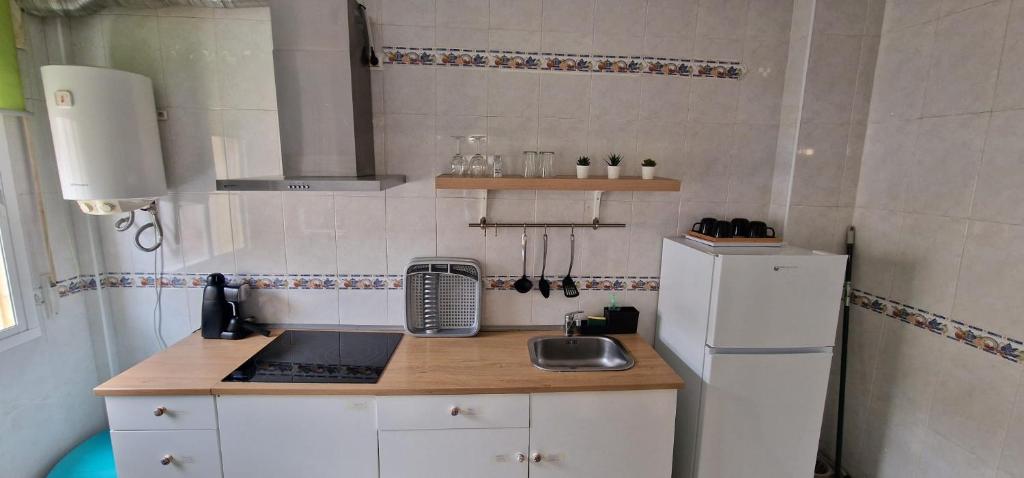 małą kuchnię ze zlewem i lodówką w obiekcie apartamento céntrico jerez calle tucan n17 w mieście Jerez de la Frontera