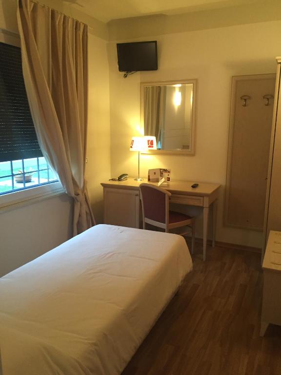 Postel nebo postele na pokoji v ubytování Albergo La Quiete