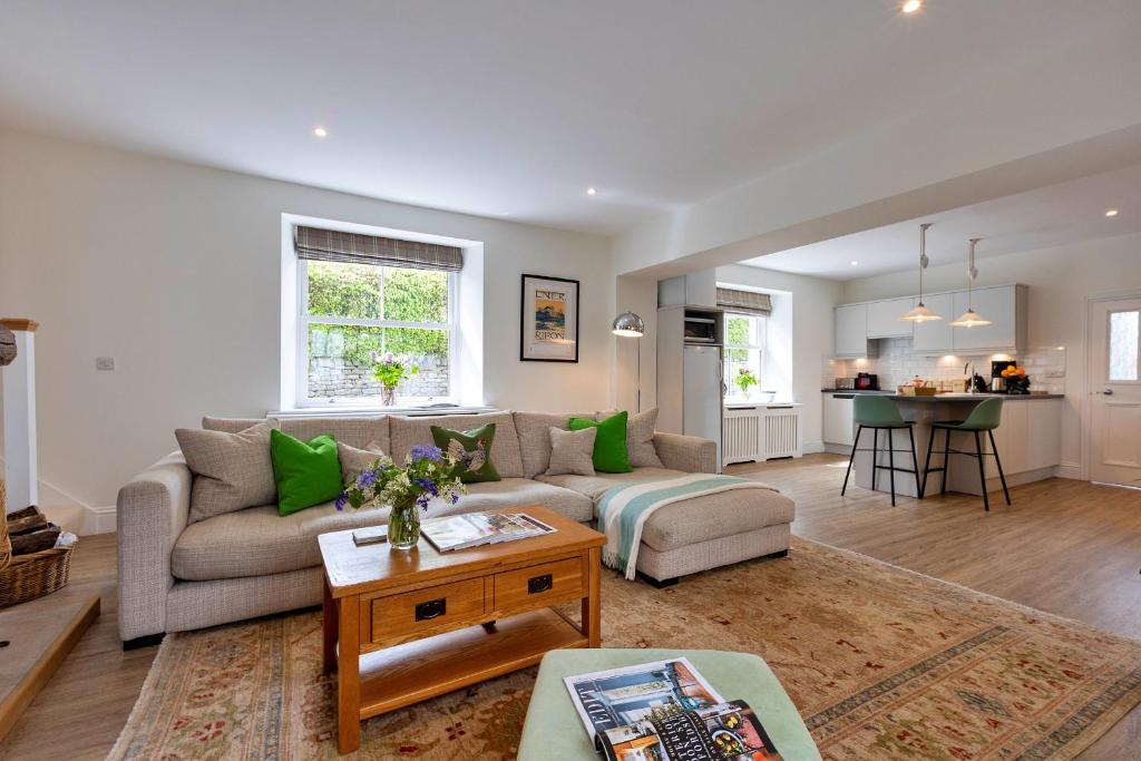a living room with a couch and a table at Finest Retreats - The Old Estate Office Nr Grantley Hall in Grantley