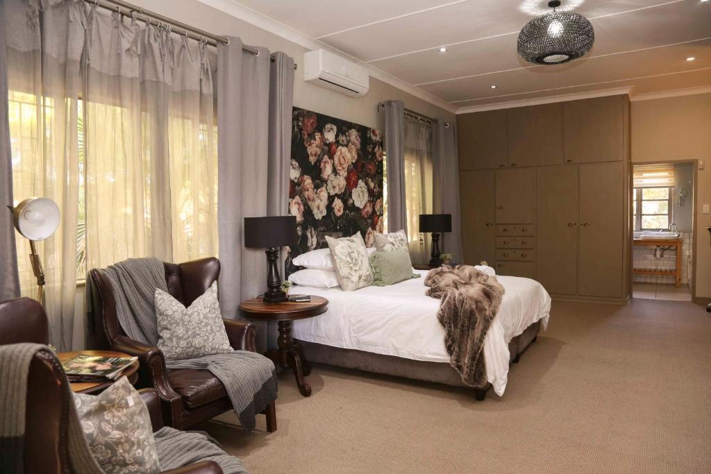 a bedroom with a bed with a dog laying on it at Ben's Bed and Breakfast in Pretoria