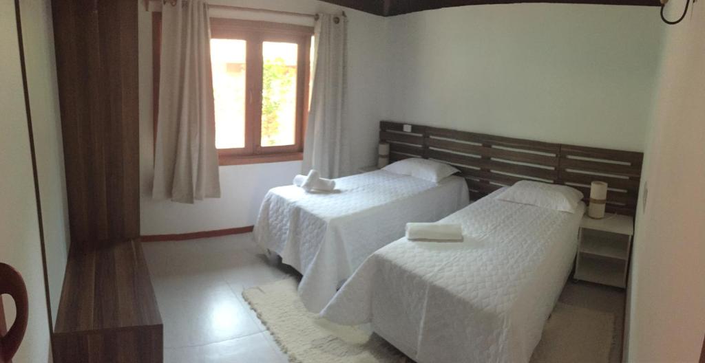 Postel nebo postele na pokoji v ubytování Cores do Arraial Residence Hotel