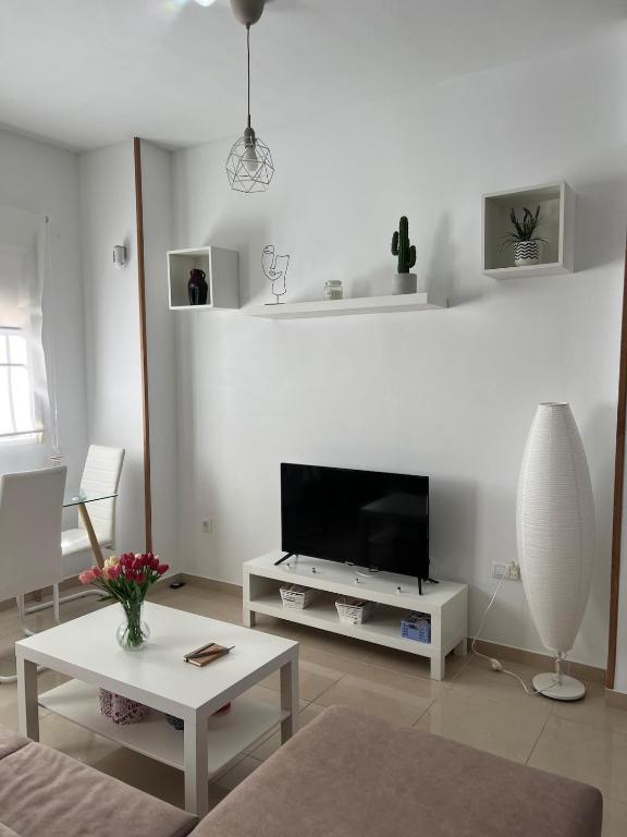 a white living room with a flat screen tv at Estudio zona residencial in Don Benito