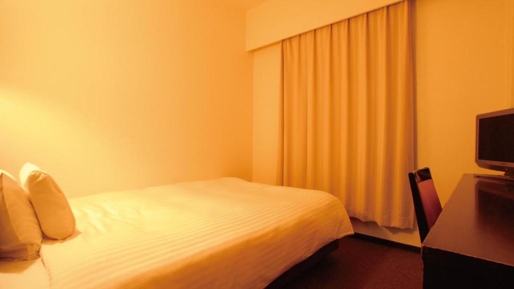 Postel nebo postele na pokoji v ubytování AB Hotel Mikawa Anjo Shinkan